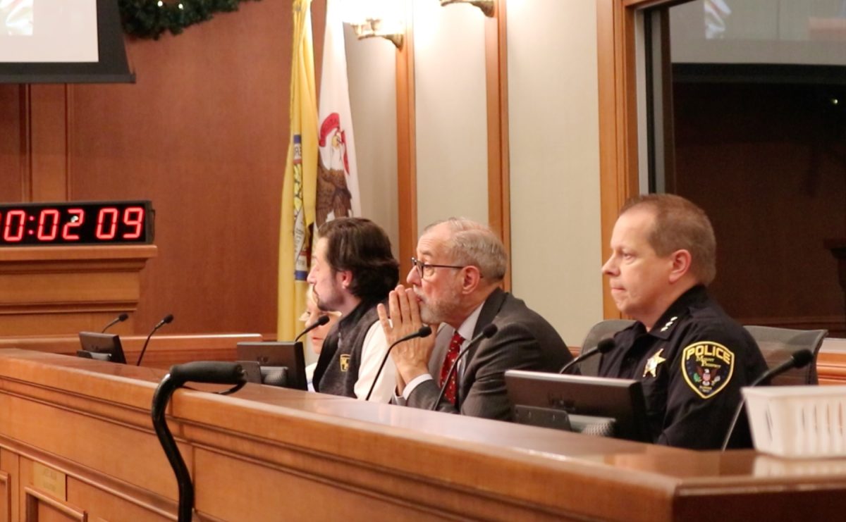 Village Attorney Lance Molina tenses during the immigration enforcement public comment segment of the December 2nd meeting. To his right is Mount Prospect Police Chief Michael Eterno.