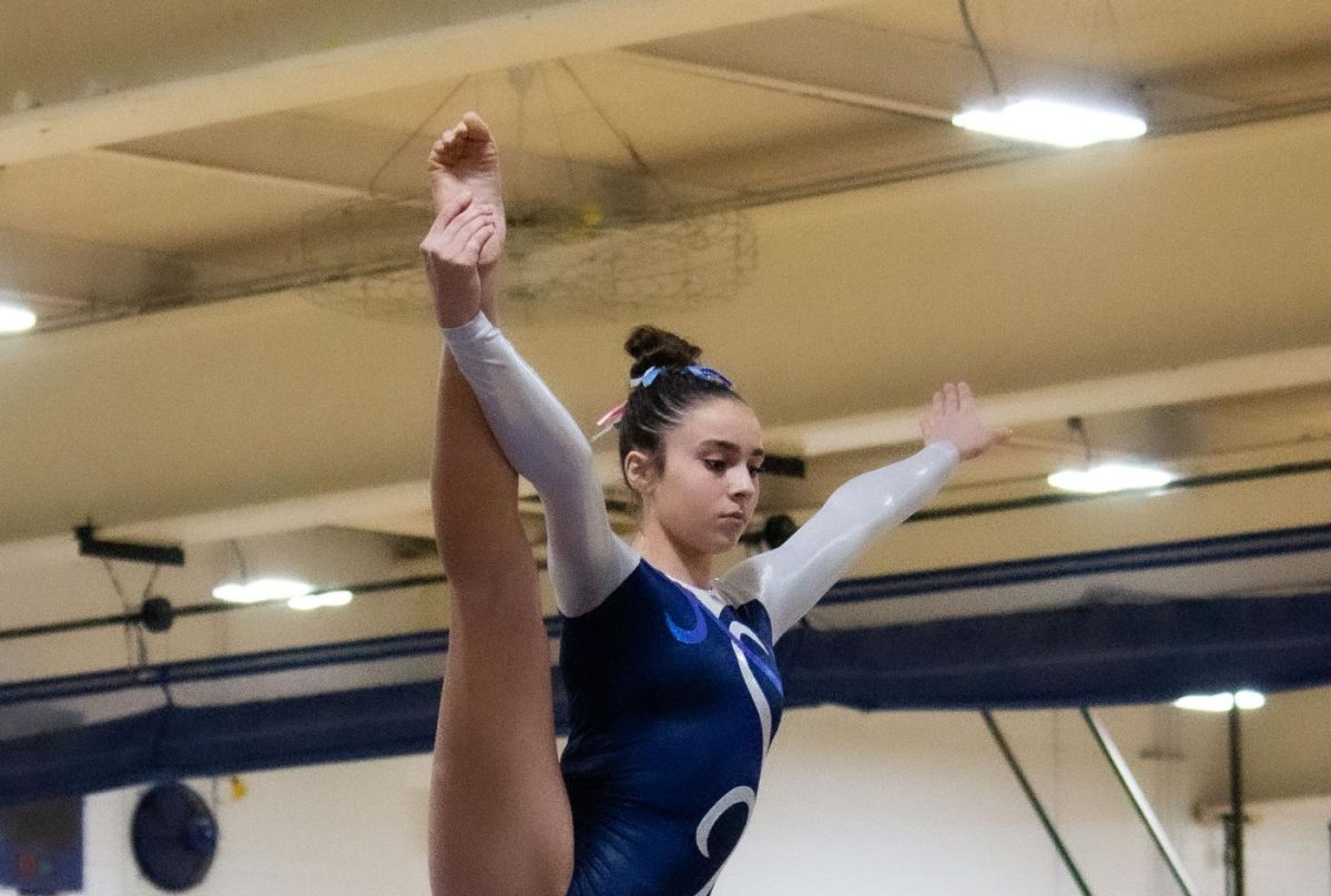 BALANCING: Freshman Angelina Figueroa does her beam routine. (photo by Violet Cantu)