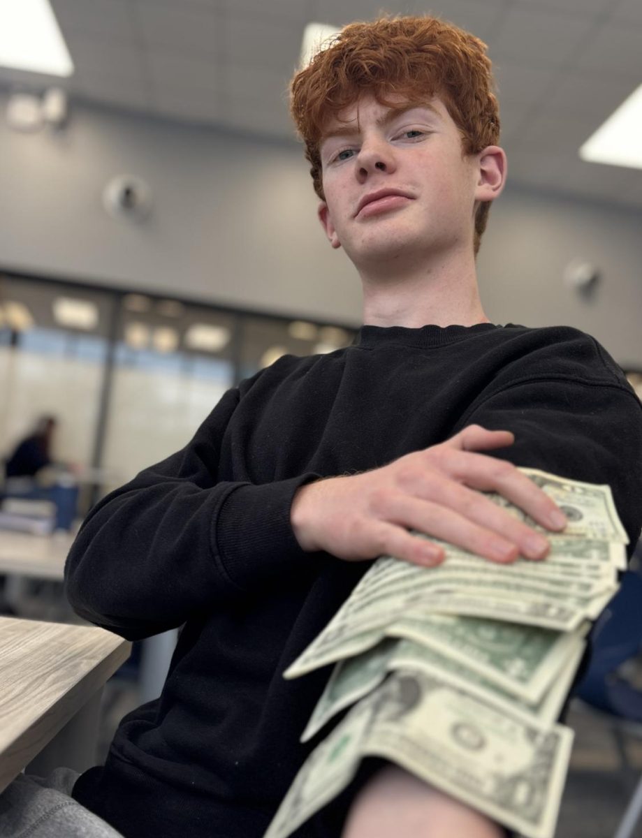 LOADED: District investing champion Eamon Walsh poses with money.