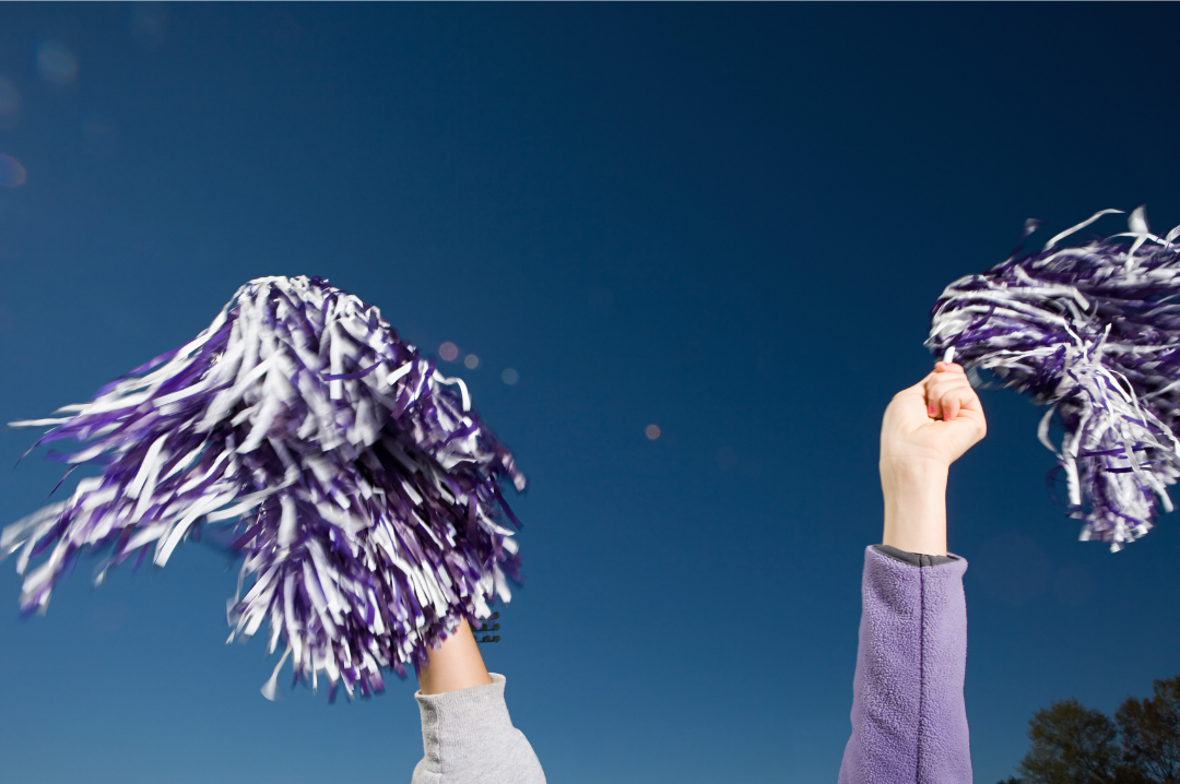 TEAM SPIRIT: A cheerleader throws their pom-poms above their head. The anonymous ex-cheer student loved cheerleading, but felt her environment was too toxic to continue. "I was just so scared of this coach," she said. "[I was scared of] the constant yelling at us and the way it was very much like, 'You're replaceable.'" (photo from Canva)