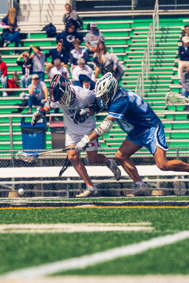 Senior Dylan Matray fights for the ball against Saint Viator's Pluto Polyzois